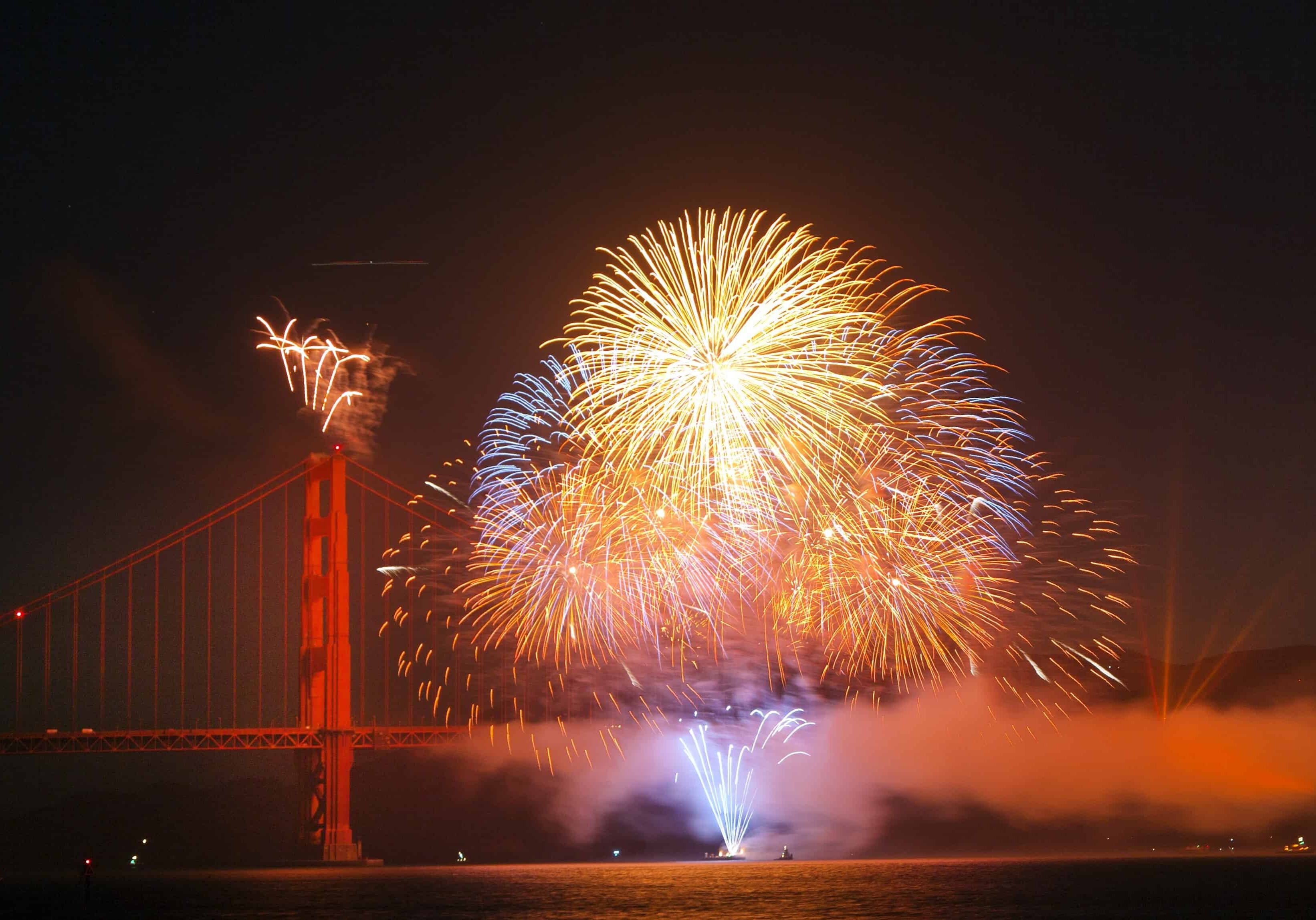 fireworks exploding over the Golden Gate bridge on 4th of July